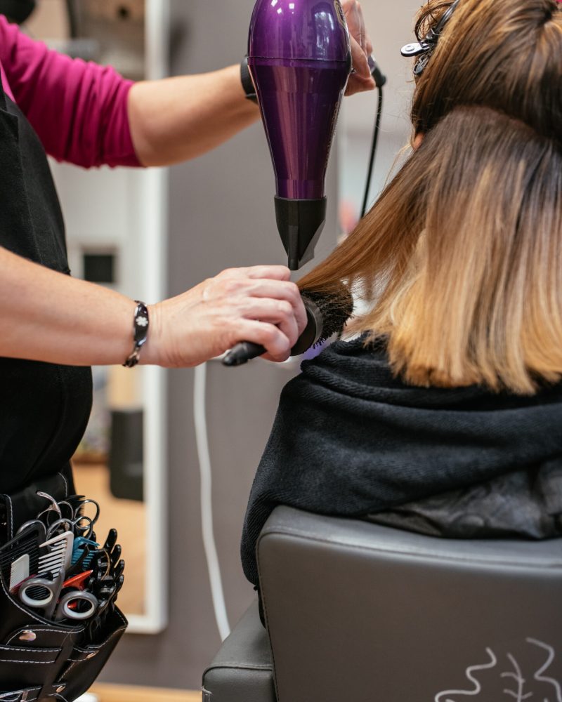 Hairdresser drying woman's hair